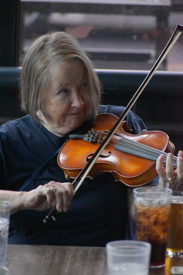 Violinist Mary Ball plays during a session at the Tavern in Littleton on Aug. 17, 2023.